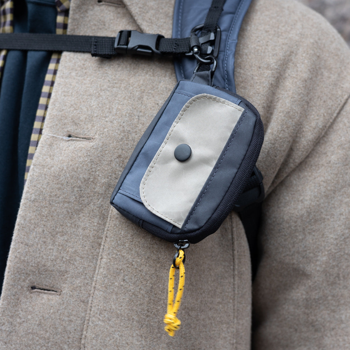 Ian Coin Pouch Coal Navy Khaki worn on a coat