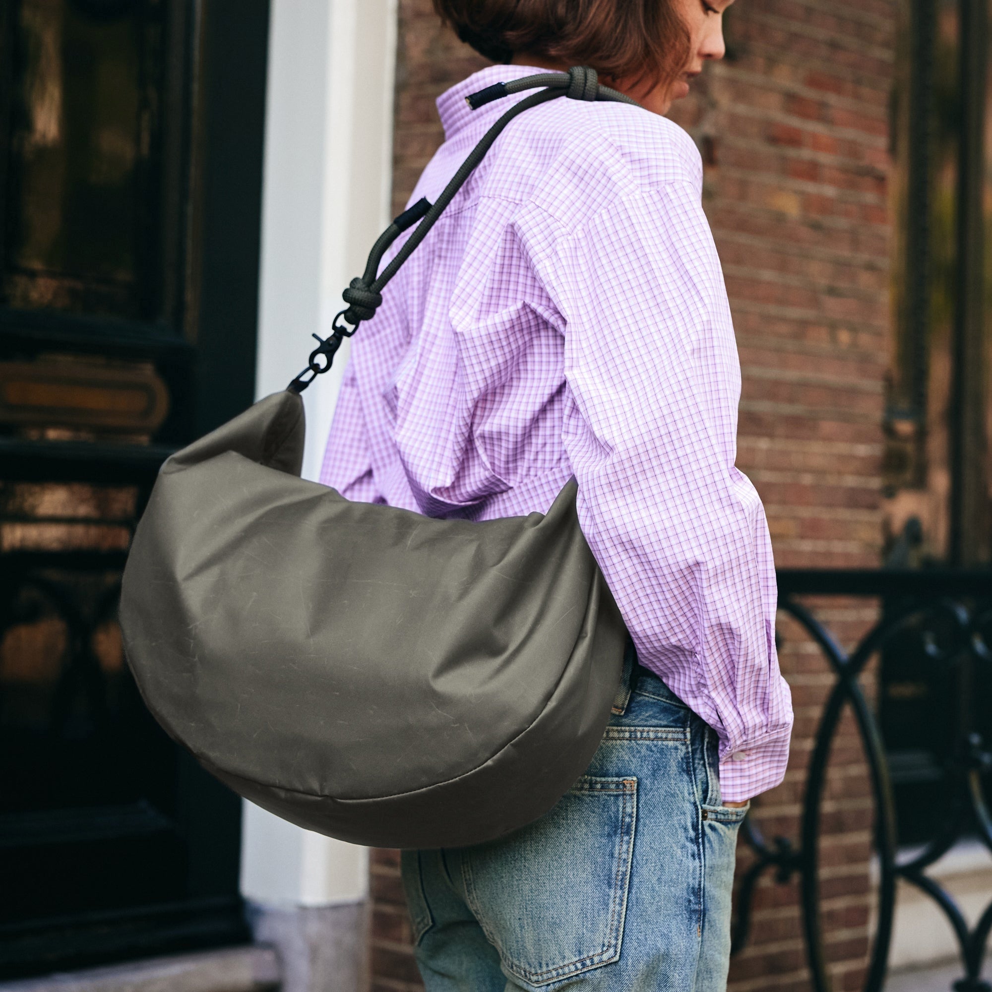 Lea Sling Bag Dark Forest worn over the shoulder