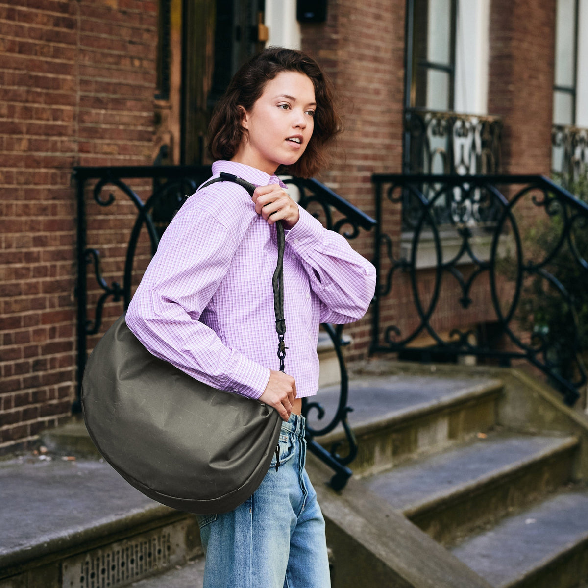 Lea Sling Bag Dark Forest on the street