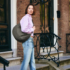 Lea Sling Bag Dark Forest carried at the hip